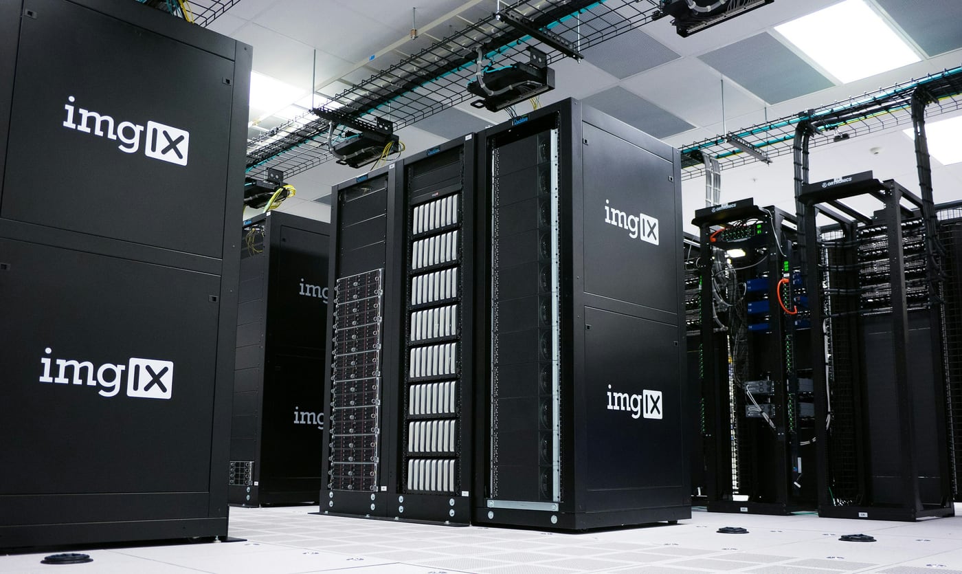 Rows of black server racks with white logos in a data center