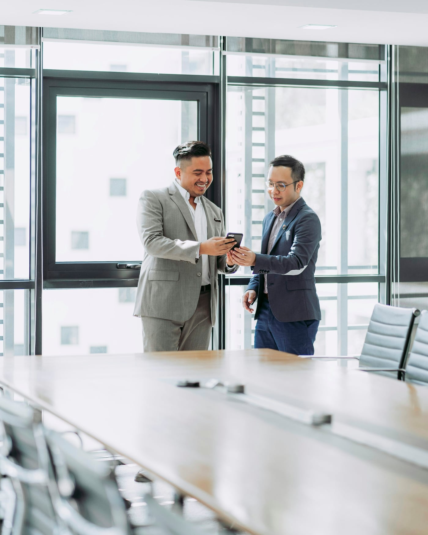 Business professionals using a mobile device in an office